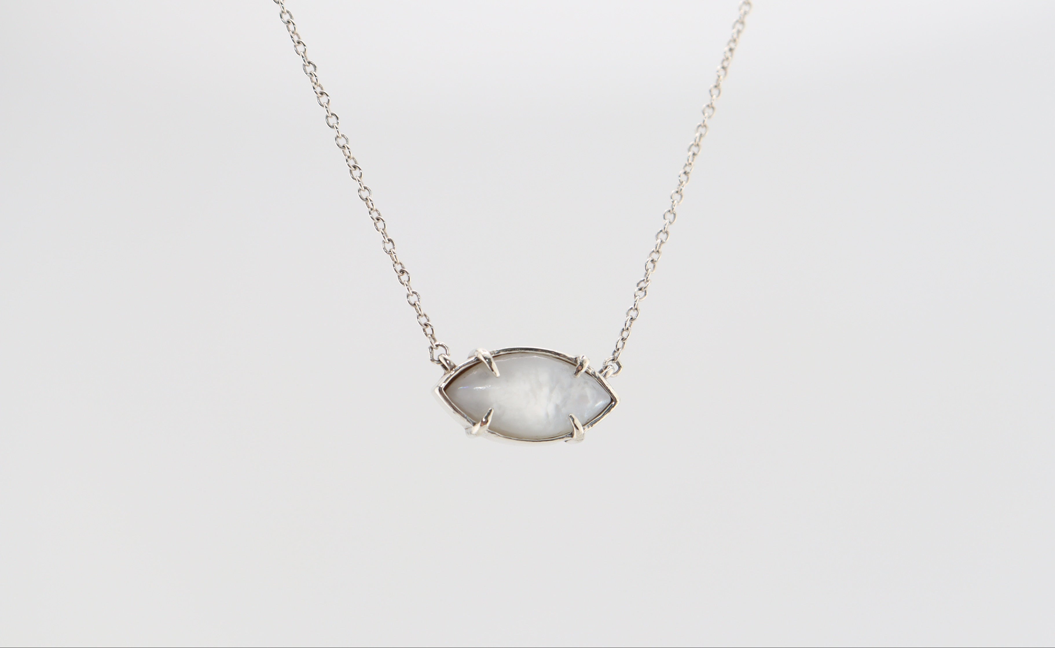 Silver necklace with mother of pearl set in a marquise pendant on a white background